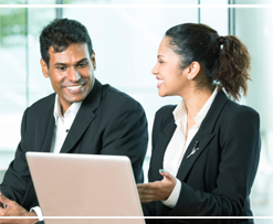 Man and woman working on computer